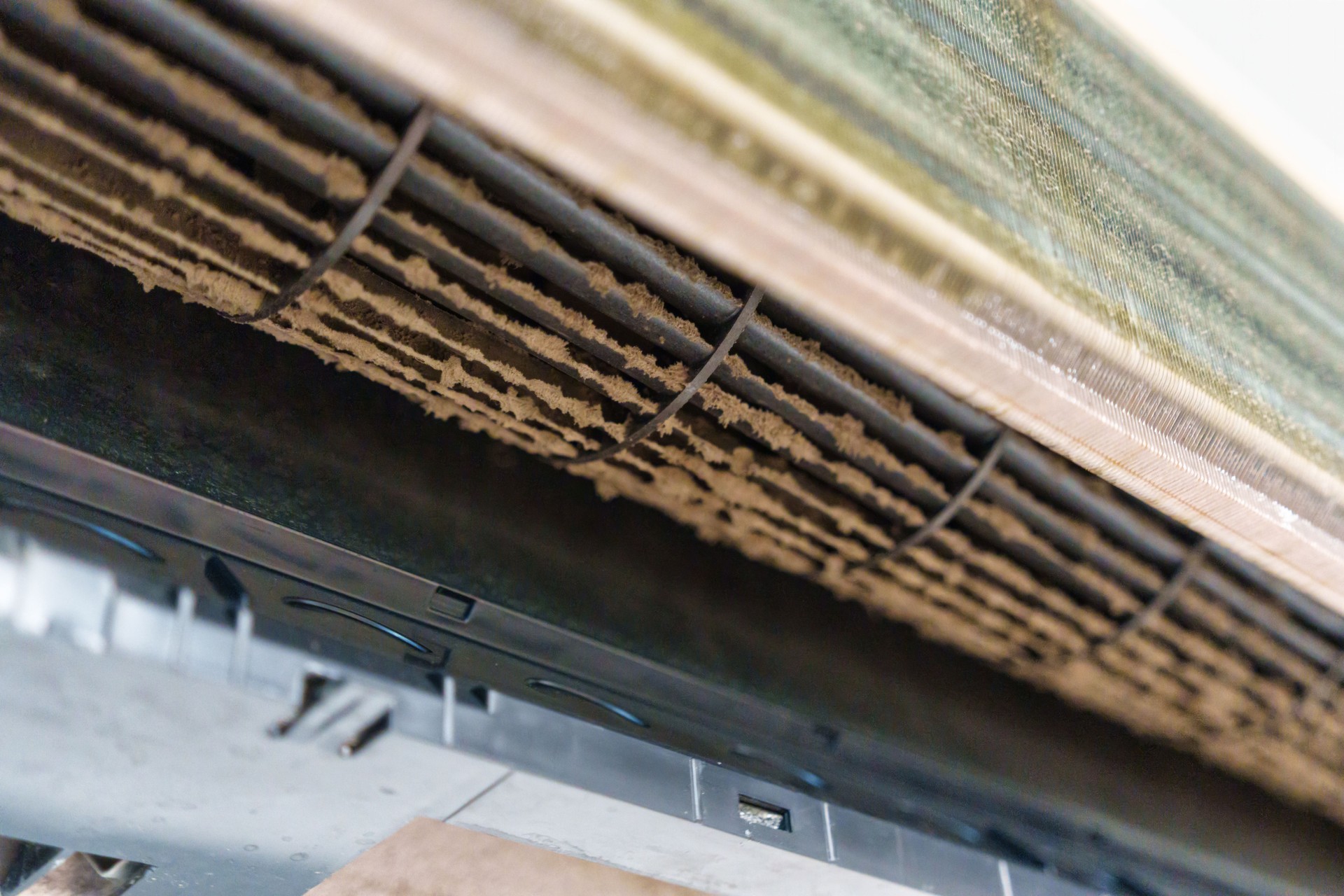 Remove and cleaning dirty air conditioner with dust covered fan blades and coils